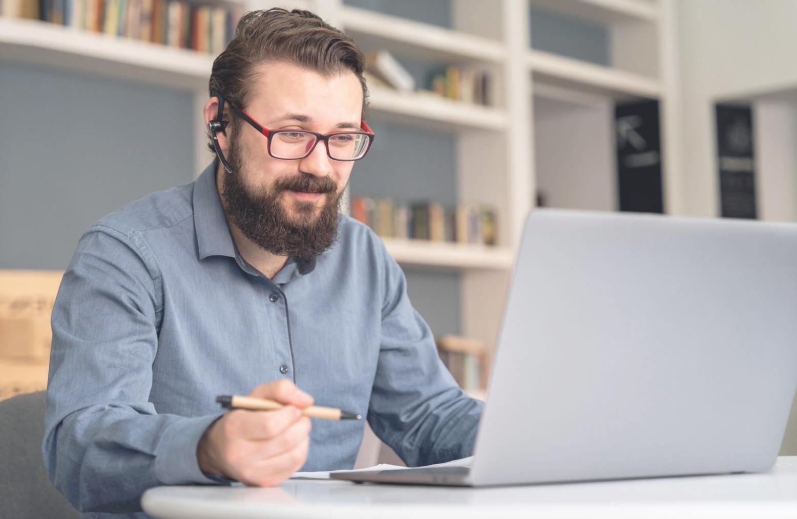 Person reviewing financial documents with thoughtful expression, demonstrating mindful money management approach